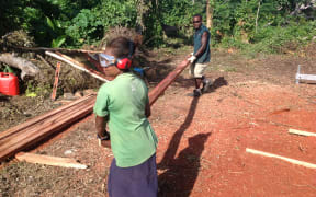 Villagers on Tanna Island in Vanuatu learn to mill their own timber as part of the cyclone rebuild.