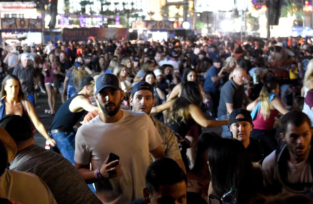 People flee the country music festival grounds.