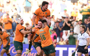The Wallabies celebrate a late win over the Pumas in Townsville.