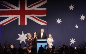Australian Prime Minister Scott Morrison arrives to speak to party supporters flanked by his wife Jenny, and daughters Abbey, left, and Lily after his opponent Bill Shorten conceded defeat in the federal election.
