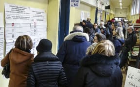 People line up to vote for general elections on March 4, 2018 at a polling station in Turin.