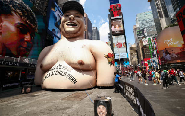 An inflatable effigy of SpaceX CEO Elon Musk, protesting Musk's Grok AI, stands in Times Square in New York City on June 11, 2026. SpaceX entered the final stretch Thursday before its expected trading on Wall Street as part of the biggest initial public offering in history, which could propel co-founder Elon Musk to trillionaire status. If all goes as expected, the space and rocket company co-founded by Musk in 2002 will begin trading on the Nasdaq exchange on Friday morning, with all eyes on how Wall Street will absorb the blockbuster IPO that could send tremors across global markets. (Photo by CHARLY TRIBALLEAU / AFP)