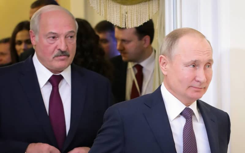 (FILES) This file photo taken on December 20, 2019 shows Russian President Vladimir Putin (R) followed by Belarusian President Alexander Lukashenko (L), entering a meeting hall during the Supreme Eurasian Economic Council, in Saint Petersburg. -