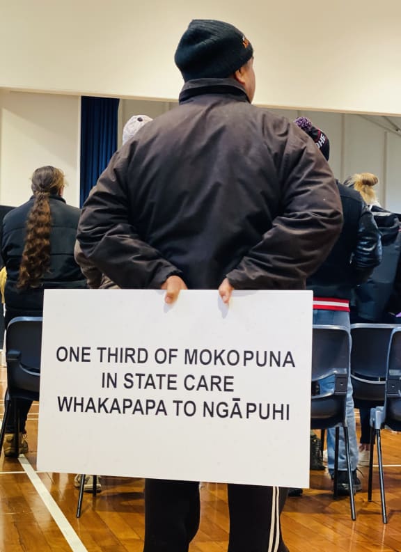 One of the attendees of the rally holding a sign.