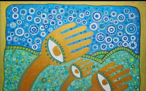 An intricate painting showing three hands with eyes at the centre blowing in a breeze, with green hills and bedazzled blue sky in the background.