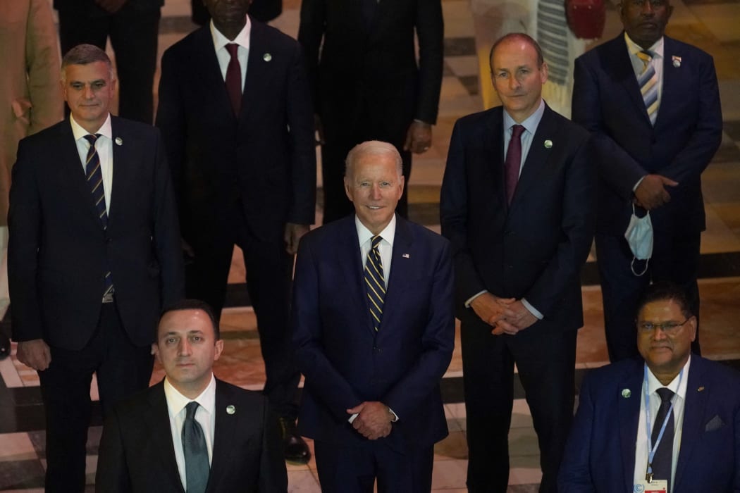 US President Joe Biden (centre) joins other world leaders posing for a group photo at an evening reception to mark the opening day of COP26.