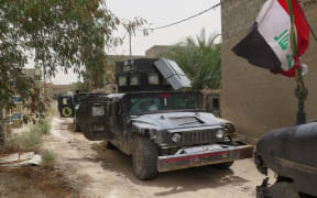 Iraqi counter terrorism force vehicles parked on a street in Falluja on 16 June 2016.