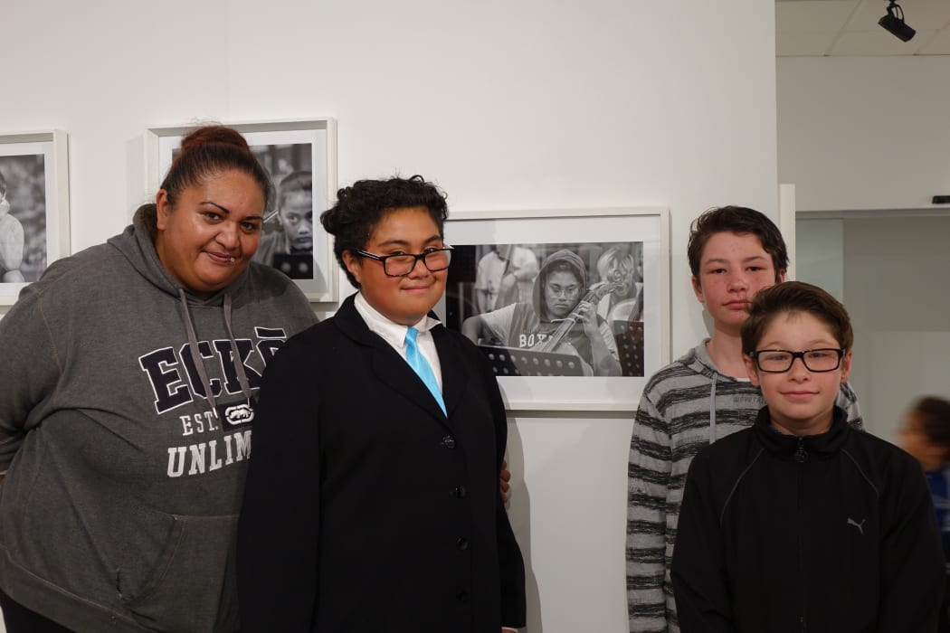 Crimson Katipa and his family at the Virtuoso Strings photo exhibition