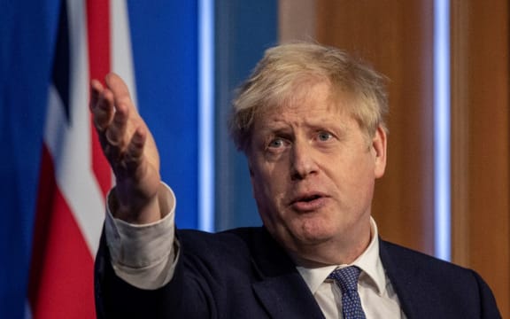 Britain's Prime Minister Boris Johnson speaks during a virtual press conference to update the nation on the status of the Covid-19 pandemic, in the Downing Street briefing room in central London on January 4, 2022.)