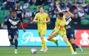 Phoenix striker Bozhidar Kraev is fouled by Melbourne Victory's Jordi Valadon in their first leg semi-final of the A-League at AMMI Park in Melbourne.