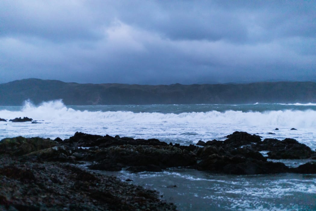 Waves break on Breaker Bay this evening as the size of the swell increases.