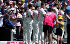 Ahmed Al Ahmed, the man who tackled and disarmed one of the Bondi beach attackers, walks onto the Sydney Cricket Ground  during a ceremony honouring emergency workers and survivors of the shooting, before the start of fifth Ashes cricket Test match between Australia and England, 4 January, 2026.  (Photo by DAVID GRAY / AFP)