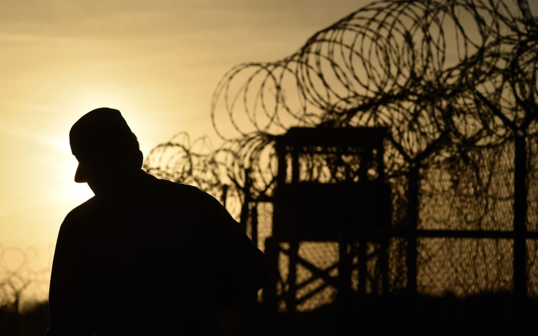 A US soldier walks next to a razor wire-topped fence at an abandoned detention facility at the US Naval Station in Guantanamo Bay (file).