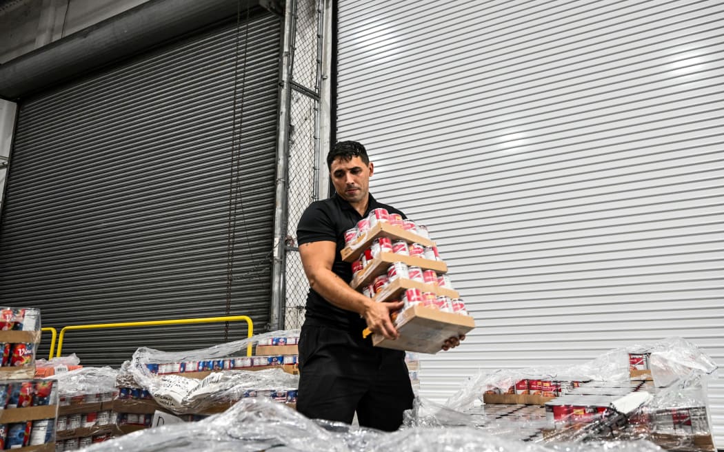 Volunteers assemble relief packages for Hurricane Melissa at the Global Empowerment Mission headquarters in Miami, Florida, on October 27, 2024. Hurricane Melissa threatened Jamaica with potentially deadly rains after rapidly intensifying into a top-level Category 5 storm, as residents scrambled for shelter from what could be the island's most violent weather on record. Melissa has already been blamed for at least four deaths in Haiti and the Dominican Republic, and was set to unleash torrential rains on parts of Jamaica in a direct hit on the Caribbean island. (Photo by CHANDAN KHANNA / AFP)