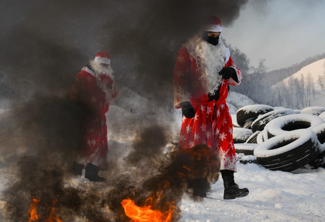 Russian National Guard officers dressed as Father Frost pass through the winter "Assault strip" in Kemerovo, Russia.