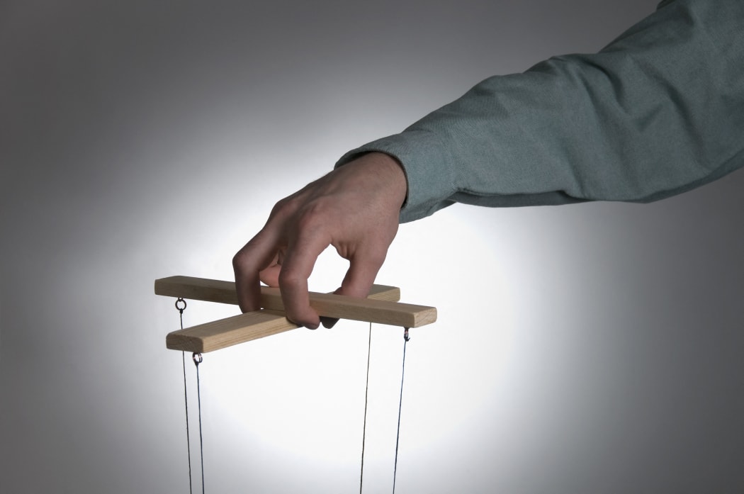 Male operating puppet controls (Photo by Chris Whitehead / Cultura Creative / Cultura Creative via AFP)