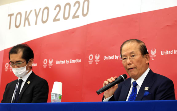 Tokyo Olympic and Paralympic Games Organising Committee CEO Toshiro Muto (R) speaks to the press alongside spokesperson Masanori Takaya (L) after a meeting with council and executive board members where Tokyo 2020 president Yoshiro Mori announced his resignation over sexist remarks.