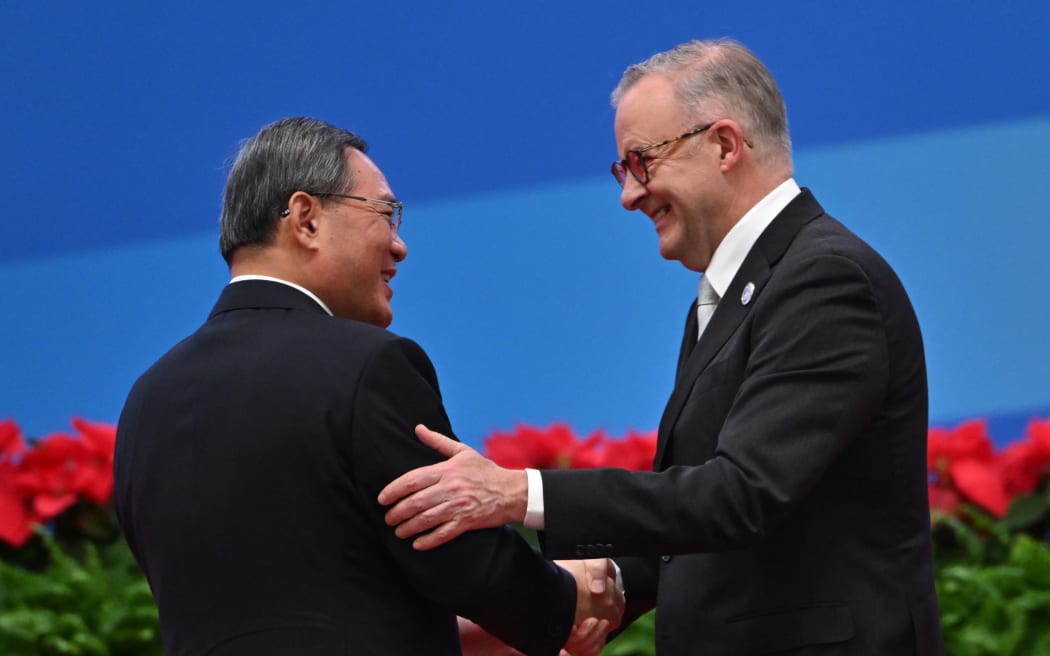 China's Premier Li Qiang (left) and Australia's Prime Minister Anthony Albanese shake hands during the opening ceremony of the 6th China International Import Expo (CIIE) in Shanghai on 5 November, 2023.