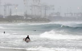 Surfers take to the water at Cottesloe beach in Perth, to take advantage of unusually large waves