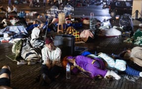 Residents take shelter ouside at a square following an earthquake in Marrakesh on September 9, 2023. Nearly 300 people were killed after a powerful earthquake rattled Morocco on September 8 night, according to a preliminary government count, with Marrakesh residents reporting "unbearable" screams followed the 6.8-magnitude quake. (Photo by Fadel SENNA / AFP)