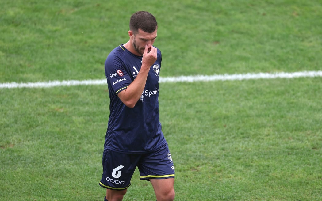 Phoenix's Tim Payne walks from the field after a red card