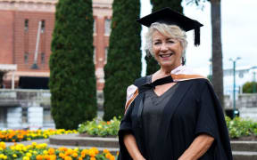 New Zealand food writer Julie Biuso wearing her university graduation cap and gown.