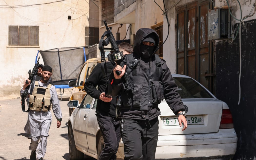 Palestinian gunmen attend the funeral of Mohammad Shahmawi after he was killed during a raid by Israeli forces on April 12, 2024, al-Faraa camp in the occupied West Bank, amid ongoing battles between Israel and the Palestinian militant group Hamas in Gaza. (Photo by Zain JAAFAR / AFP)