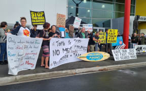 A group of people holding anti-mining signs.