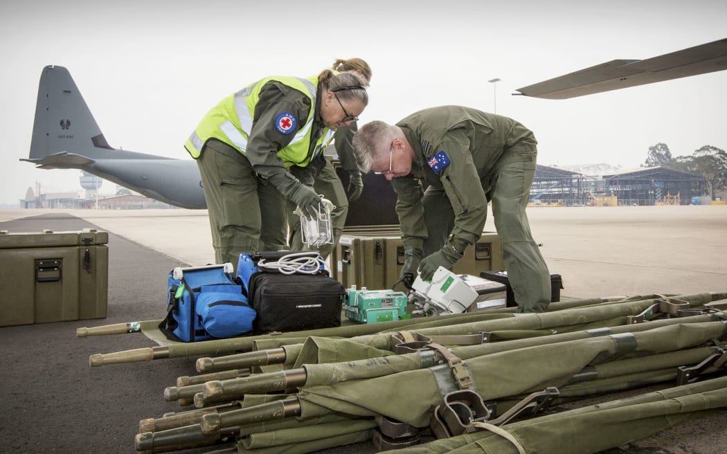 Sergeant Sheree Lewis (L) and Squadron Leader Justin Treble prepare equipment to load onto a C-130J Hercules 

White Island injured