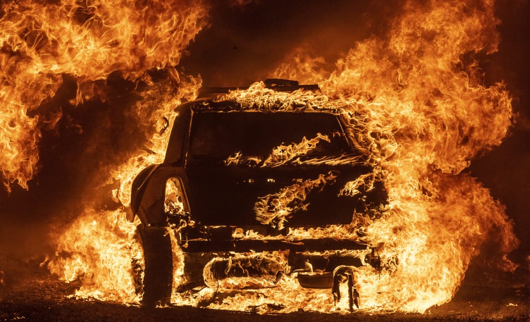 A car burns while parked at a residence in Vacaville, California during the LNU Lightning Complex fire on August 19, 2020.
