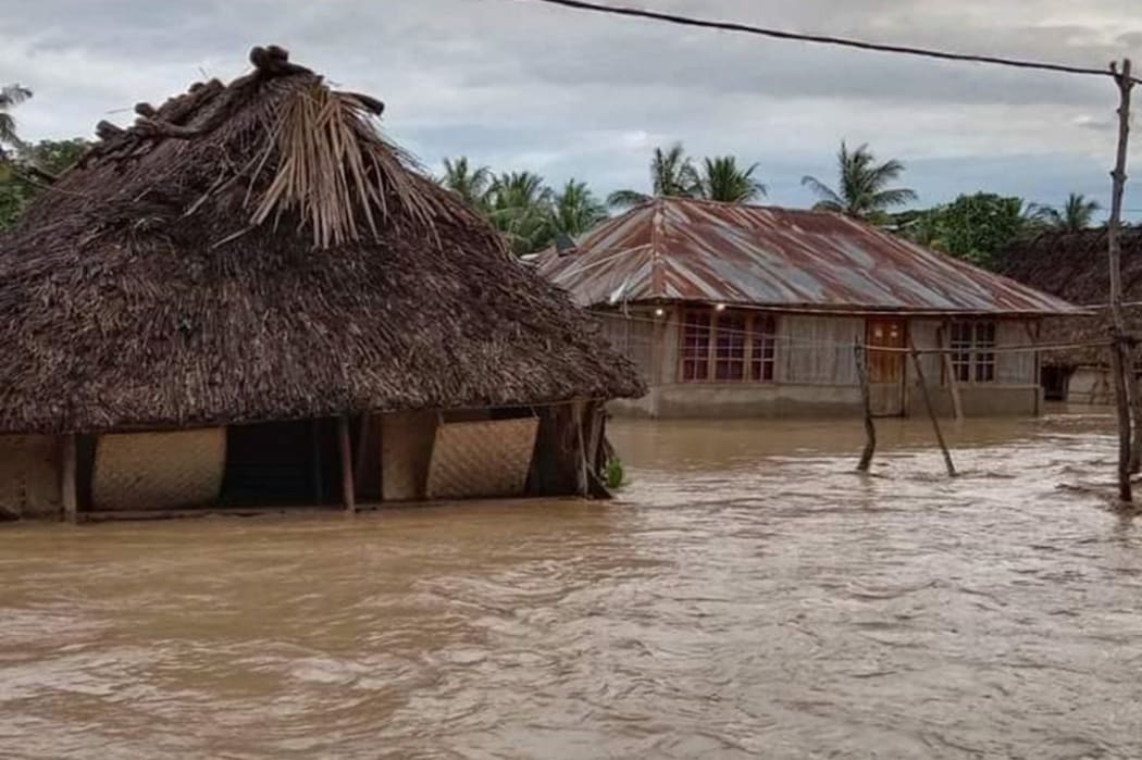 This general view shows homes surrounded by floodwaters in the village of Haitimuk in East Flores on April 4, 2021, after flash floods and landslides swept eastern Indonesia and neighbouring East Timor.