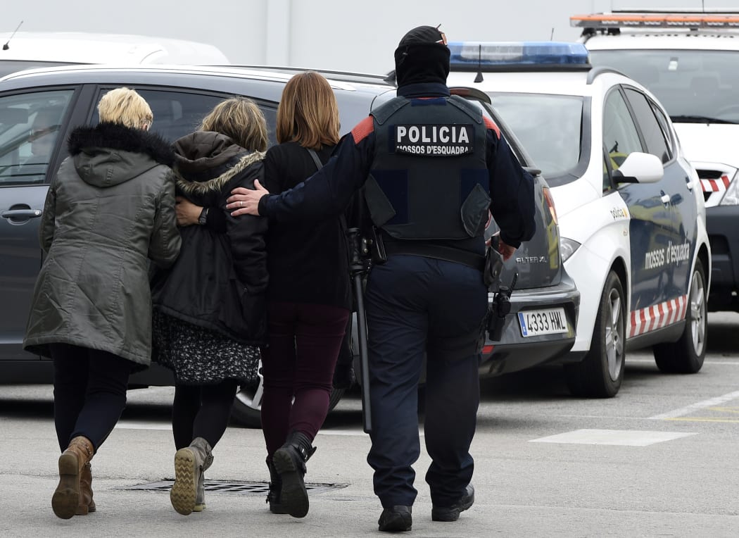 Police escort family members of an aircrash victim at Barcelona's airport.