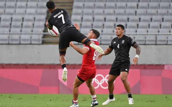 Amanaki Nicole challenges for a high ball.