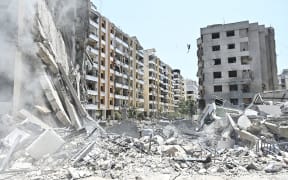 The rubble of a collapsed building is pictured at the site of an overnight Israeli airstrike in the Kafaat neighborhood of Beirut's southern suburbs in Beirut, Lebanon, on June 6, 2025. Israel warns on June 6 that it will keep striking Lebanon until it disarms the militant group Hezbollah, hours after it hits south Beirut in what Lebanese leaders call a major ceasefire violation.  (Photo by Fadel Itani/NurPhoto). (Photo by Fadel Itani / NurPhoto via AFP)