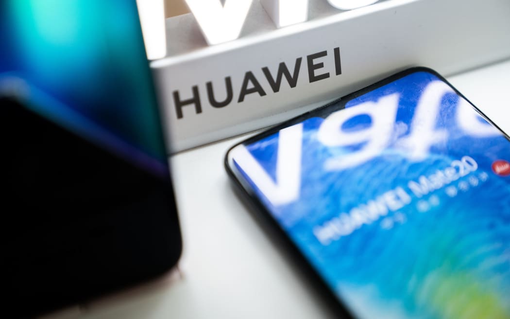 A Huawei logo is displayed at a retail store in Beijing.