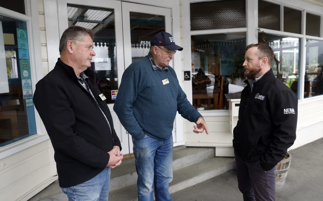 Rural Support Trust members Chris Faulls, left, and Chris Bird, meet with the Minister for Emergency Management Kieran McAnulty in Havelock on Thursday.