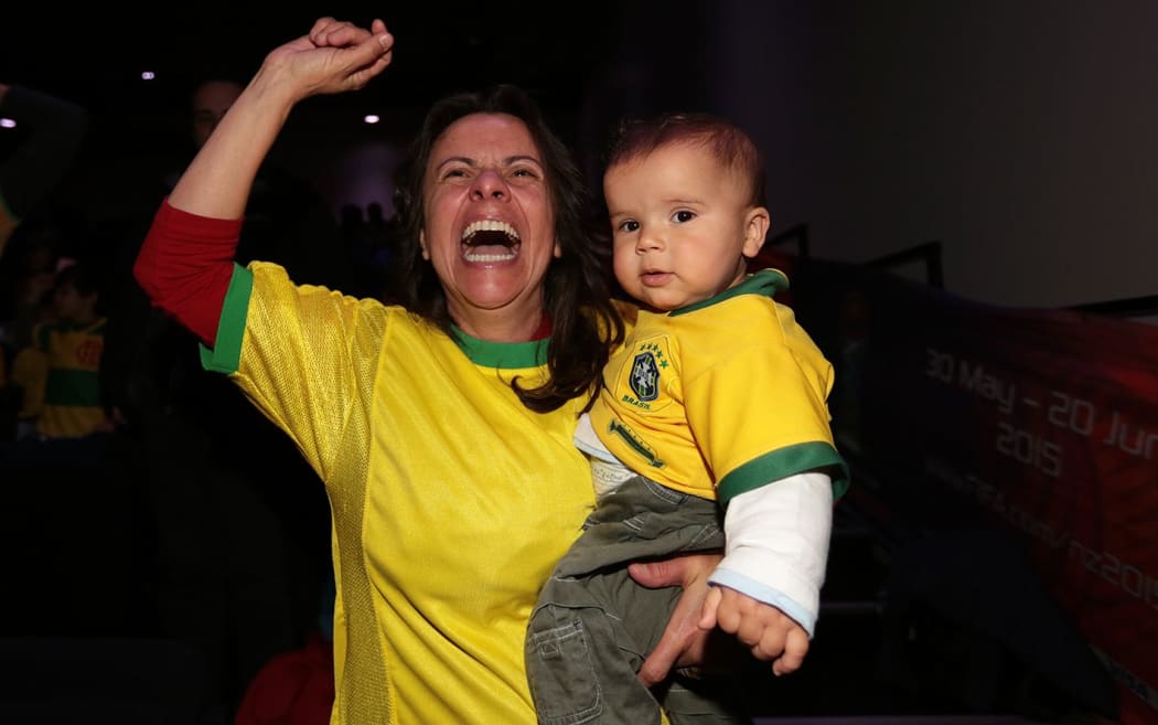 Sandra Scott and 10-month-old Victor Alexander Scott celebrating the second goal.