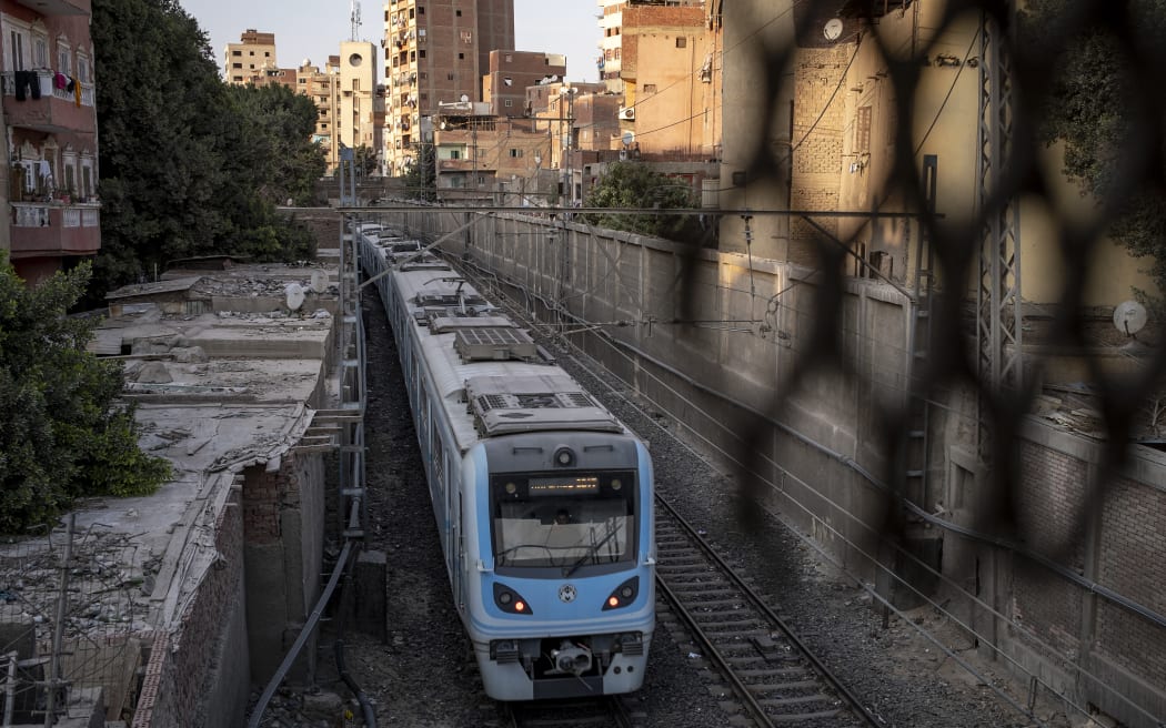 A train of the French-built Line 1 of the Cairo Metro moves along the track near Mar Girgis (St George) station in Coptic Cairo on March 8, 2024. (Photo by Amir MAKAR / AFP)