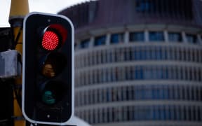 Red traffic light on front of Parliament