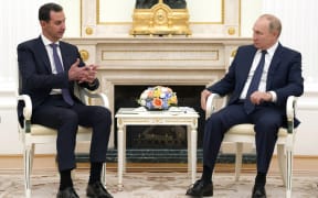Syrian President Bashar al-Assad, left, talks to Russian President Vladimir Putin during a meeting in Moscow, Russia.
