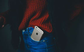 woman with iphone in jeans pocket