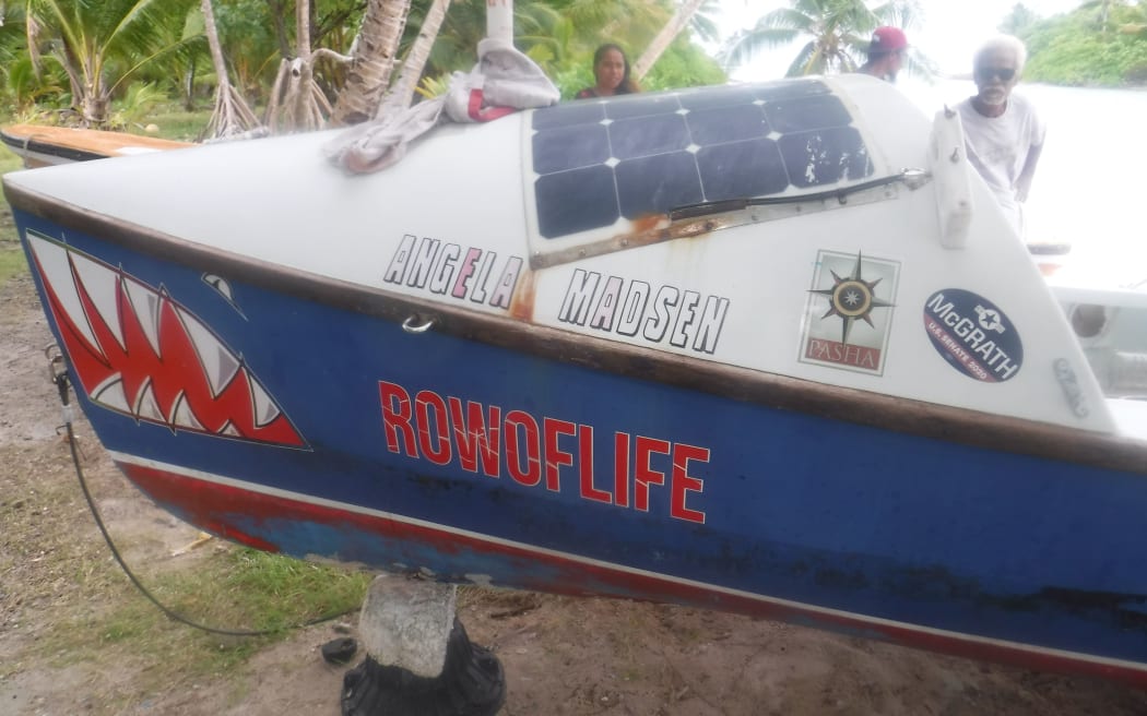 Mili Islanders look at American paralympic paddler Angela Madsen's boat, which washed up on Mili Atoll in late October - 16 months after Madsen's body was was found mid-way between California and Hawaii on her ill-fated attempt to paddle solo last year.