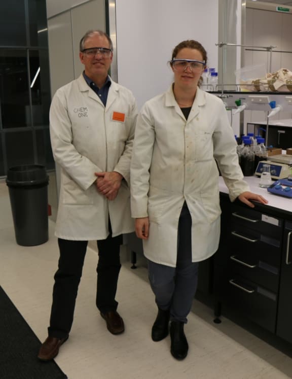 An image of Professor Paul Kilmartin and PhD student Charlotte Vandermeer wearing white coats and safety glasses, standing in the wine waste laboratory.