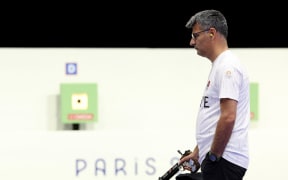 Turkey's Yusuf Dikec competes in the shooting 10m air pistol mixed team gold medal match during the Paris 2024 Olympic Games at Chateauroux Shooting Centre on July 30, 2024. (Photo by Alain JOCARD / AFP)