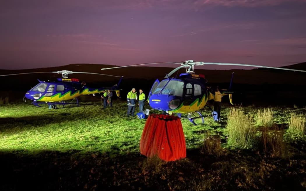 Fire crews prepare to access the Cape Reinga blaze area using helicopters this morning.