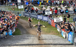 Sam Gaze in action and on the podium after victory in the short-track race at the UCI Mountain Bike World Championships in Les Gets, France, August 27 2022.