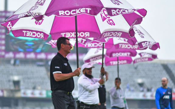 Umpires and officials inspect the field as rain washed out the second day of play during the second Test cricket match between Bangladesh and New Zealand at Dhaka, 2023.