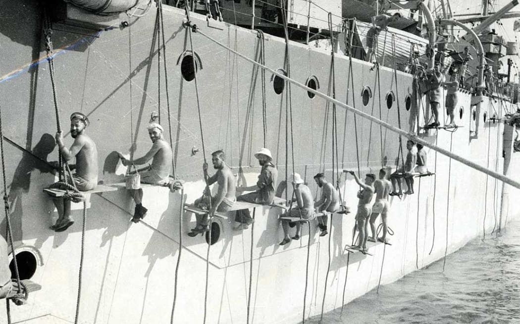 New Zealand naval ratings painting the cruiser Leander in Alexandria harbour, Egypt.