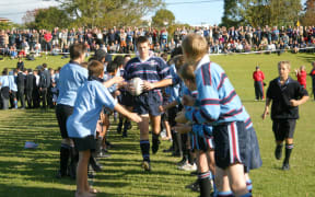 7 May 2003. 1st XV Rugby. Sacred Heart College v Kings College. Sacred Heart College, Glenn Innes, Auckland.
Sacred Heart captain Hugh McCarroll leads his team onto the field.