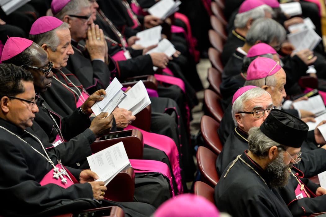 Bishops hold books as the Pope reads prayers at the morning session of the last day of the Synod on the Family at the Vatican.